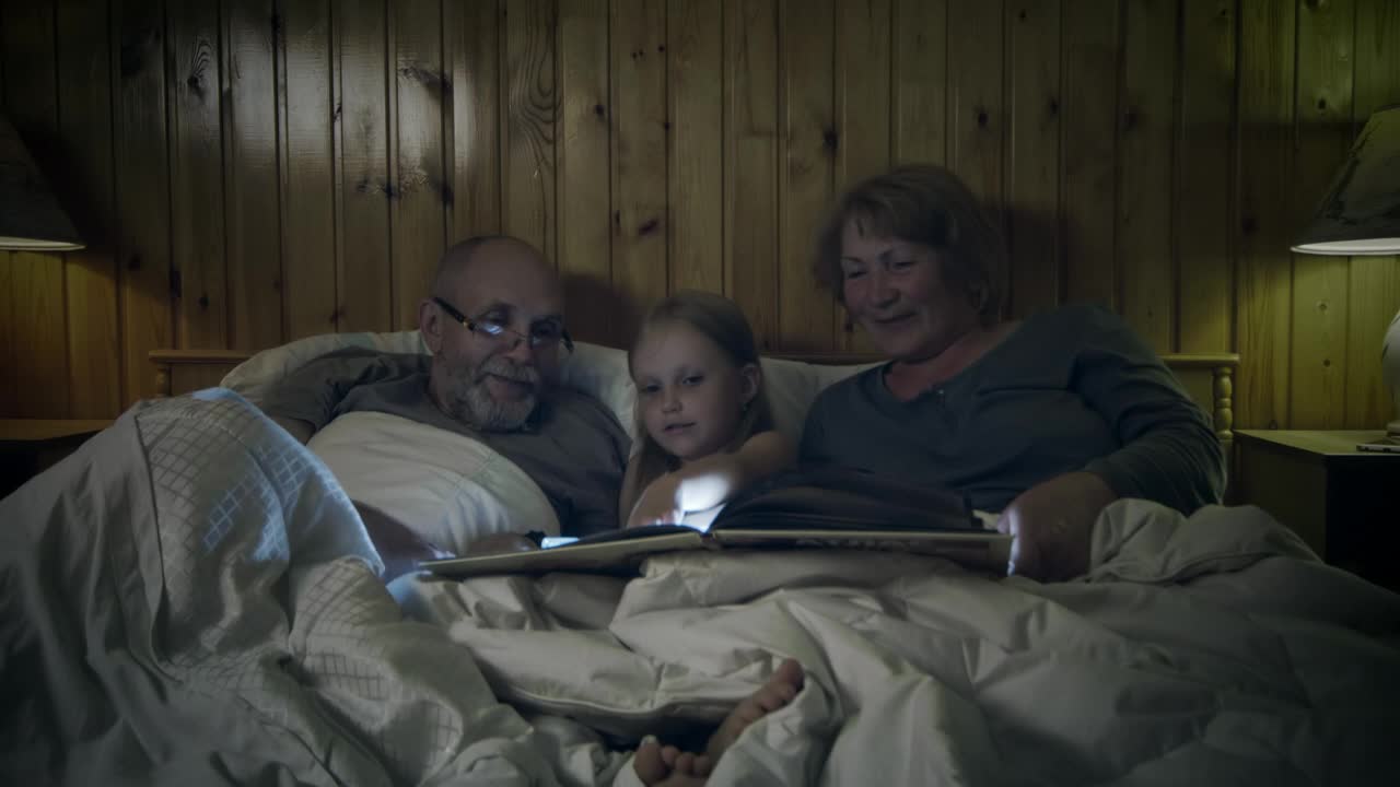 Stock Video Grandparents Reading A Story To Their Grandchild Live Wallpaper For PC - Free Download