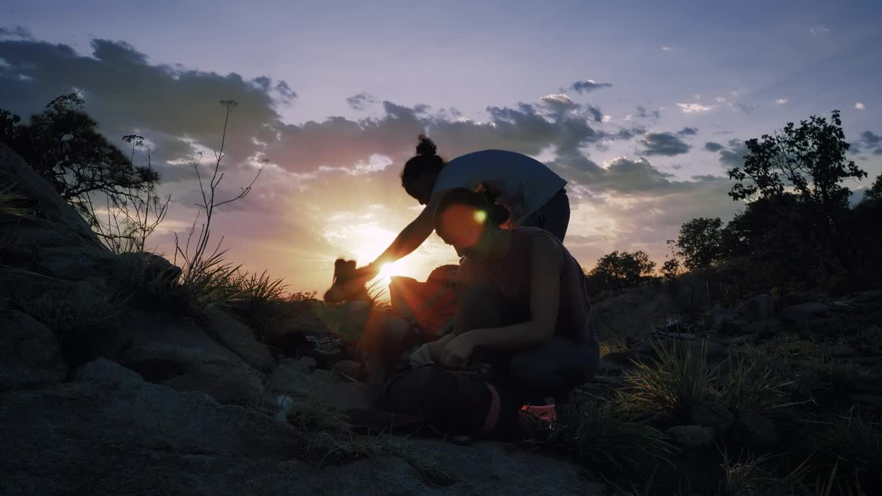 Stock Video Pair Of Mountaineers Putting Away Their Things At Sunset Live Wallpaper - Free Download