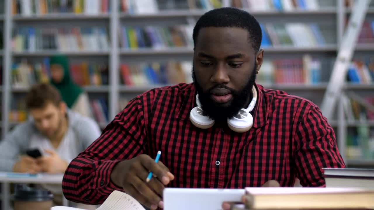Stock Video Male Student Reading In The Library Animated Wallpaper - Free Download