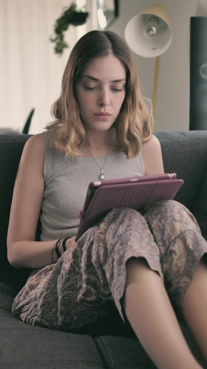 Stock Video Girl Lying In An Armchair Using An Ipad Live Wallpaper For PC - Free Download