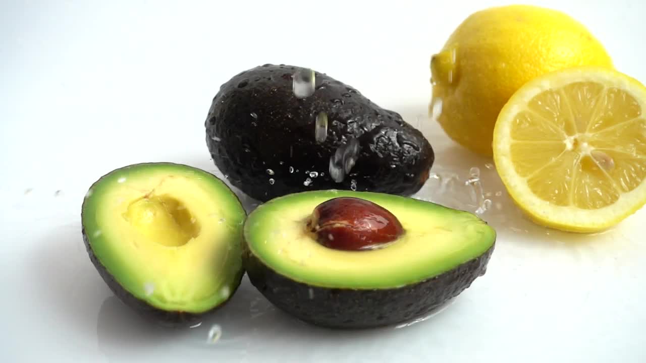 Stock Video Lemon And Avocado Being Wet By A Jet Of Water Animated Wallpaper - Free Download