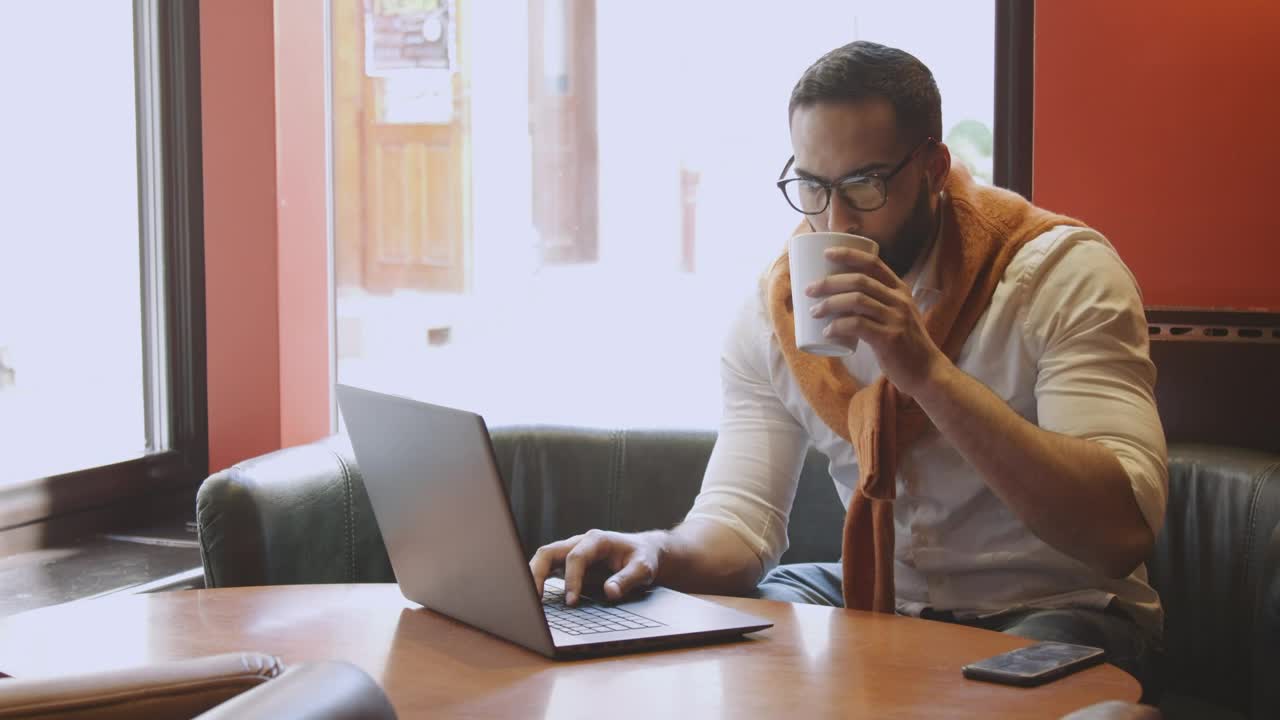Stock Footage Urban Man Sips Coffee While Working In Cafe Live Wallpaper - Free Download