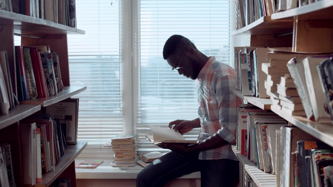 Stock Video Man Checking Books In The Library Animated Wallpaper - Free Download