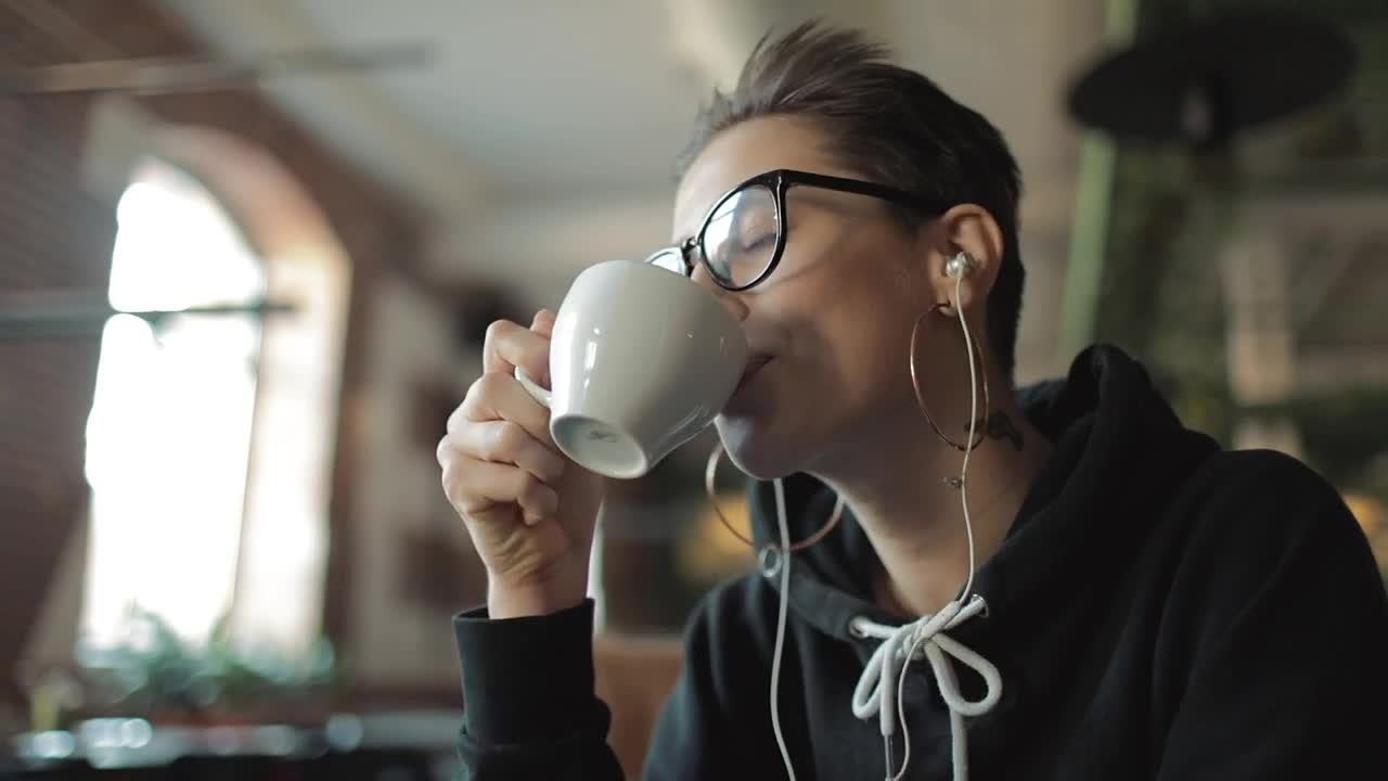 Stock Video Happy Urban Woman Sips Coffee And Listens To Music Animated Wallpaper - Free Download