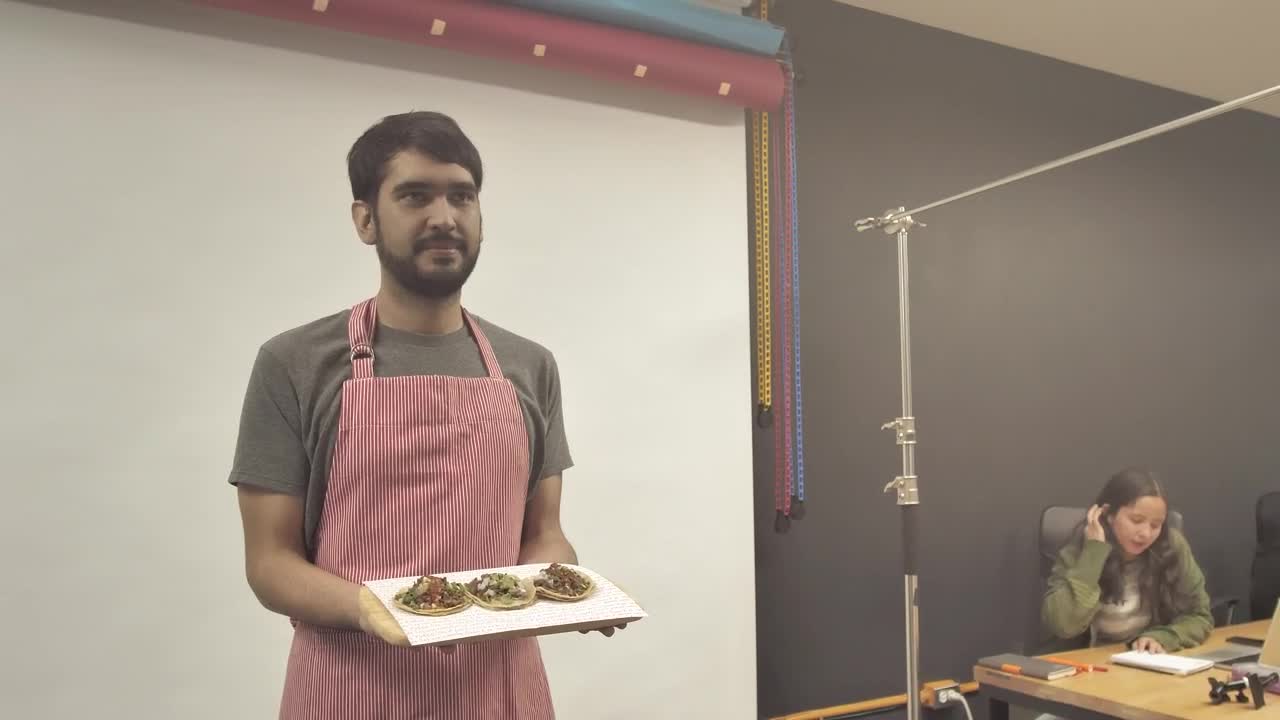 Stock Video Man In A Photo Studio Holding Food Animated Wallpaper - Free Download
