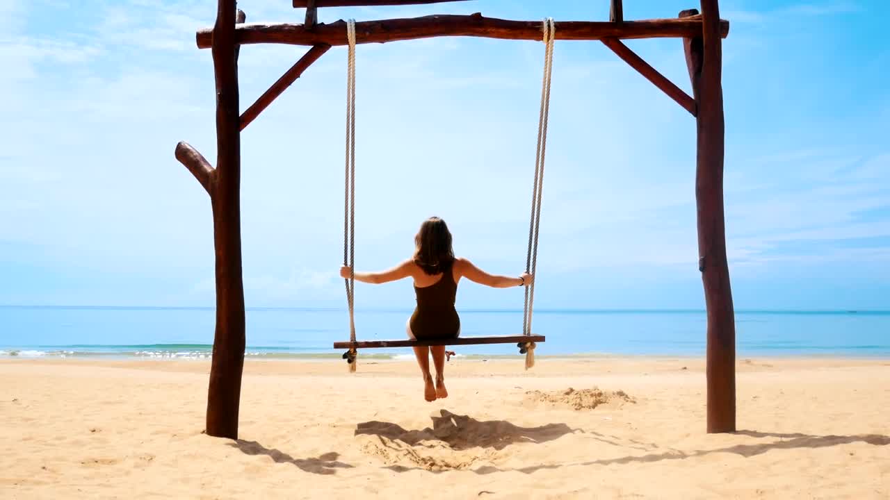 Free Stock Video Woman Swinging On A Sunny Beach Back View Live Wallpaper - Free Download