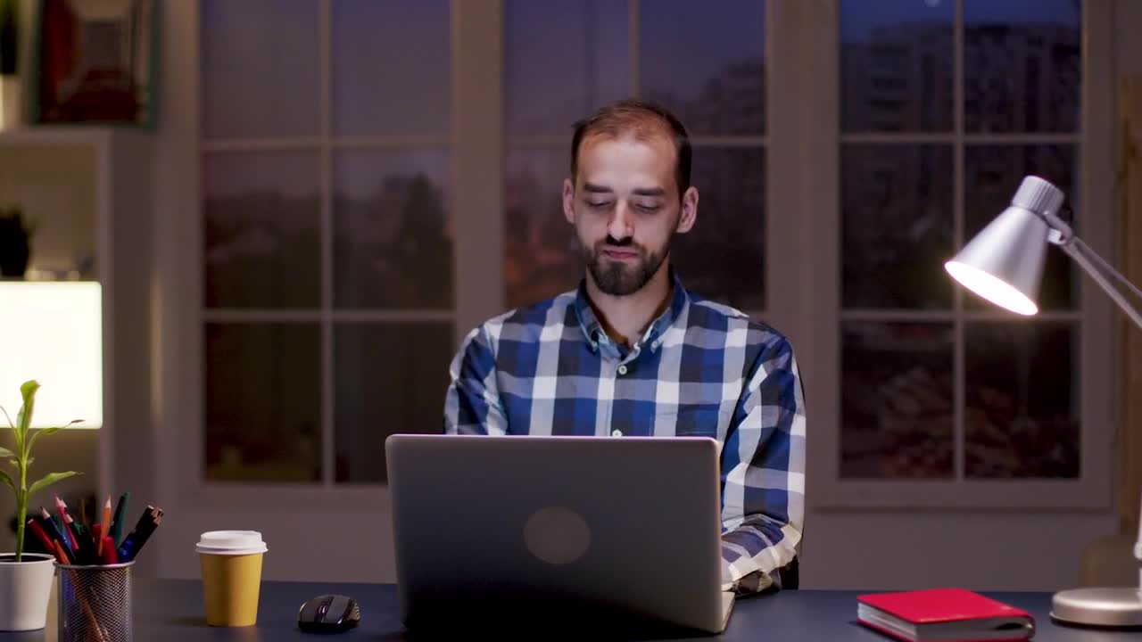 Stock Video Man Smiles While Thinking And Working From Hom Animated Wallpaper - Free Download