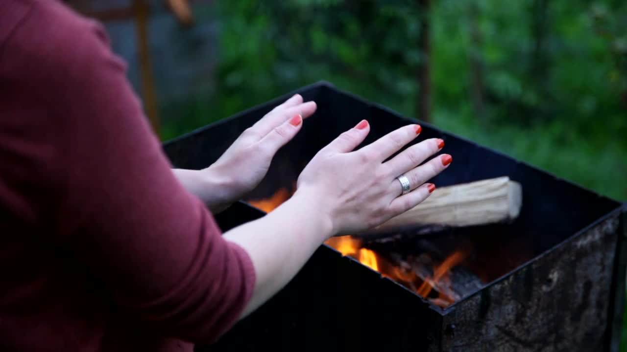 Stock Footage Warming Her Hands Over A Fire Live Wallpaper - Free Download