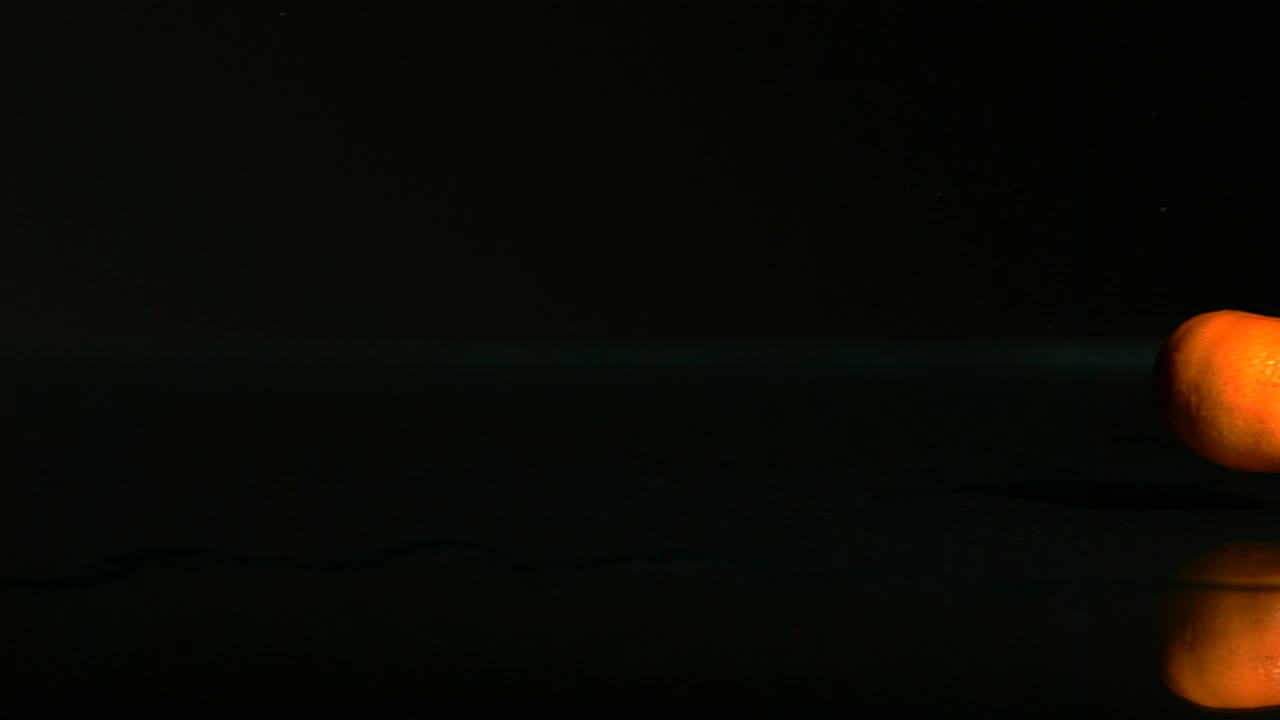 Free Video Stock tangerines rolling on a black surface Live Wallpaper - Free Download