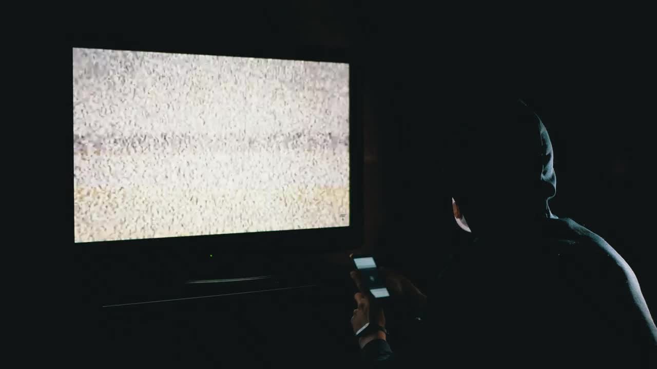 Stock Video Man Scrolling A Phone In Front Of A Televisio Animated Wallpaper - Free Download