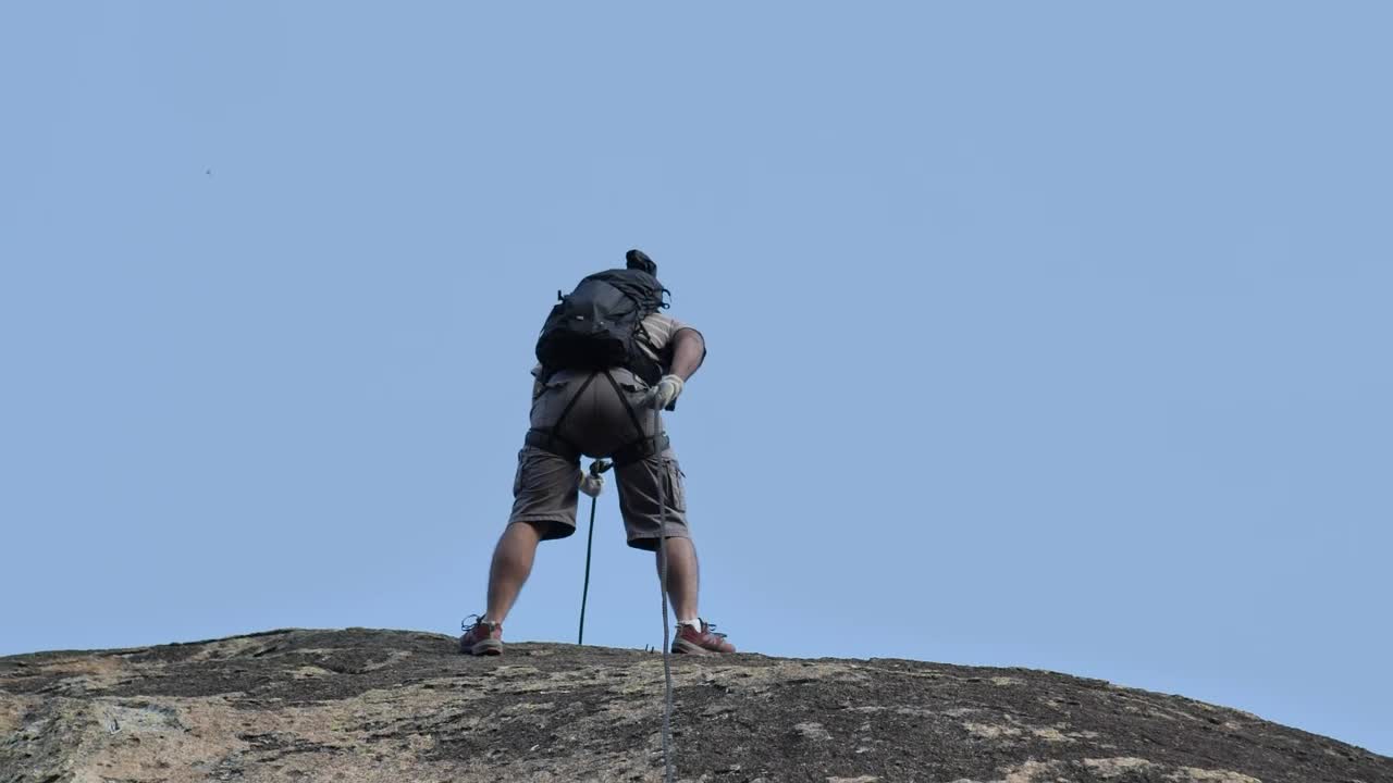 Stock Video Mountaineer Descending A Rocky Slope Live Wallpaper - Free Download
