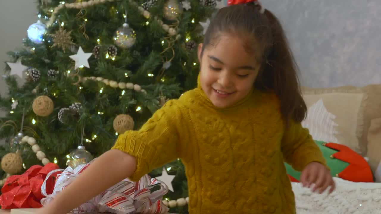 Stock Video Little Girl Opening Her Presents On Christmas Day Animated Wallpaper - Free Download