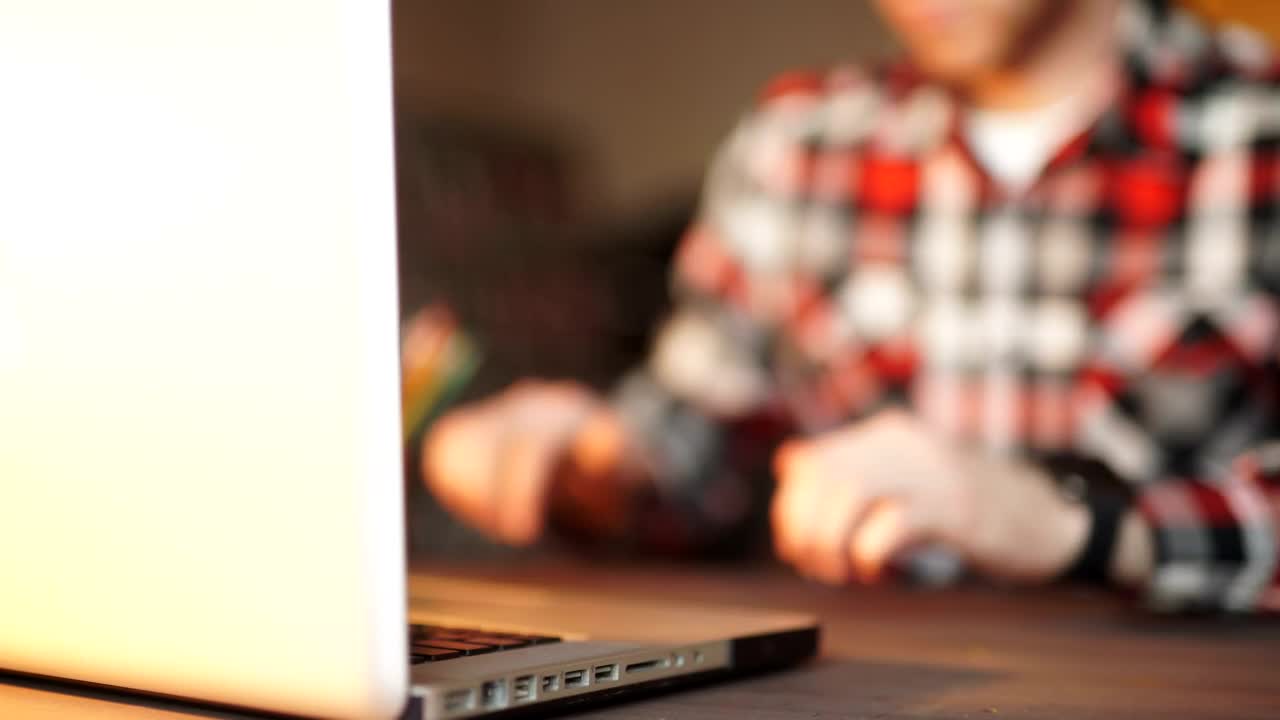 Stock Video Man Working On Laptop Looks At His Smart Watc Animated Wallpaper - Free Download