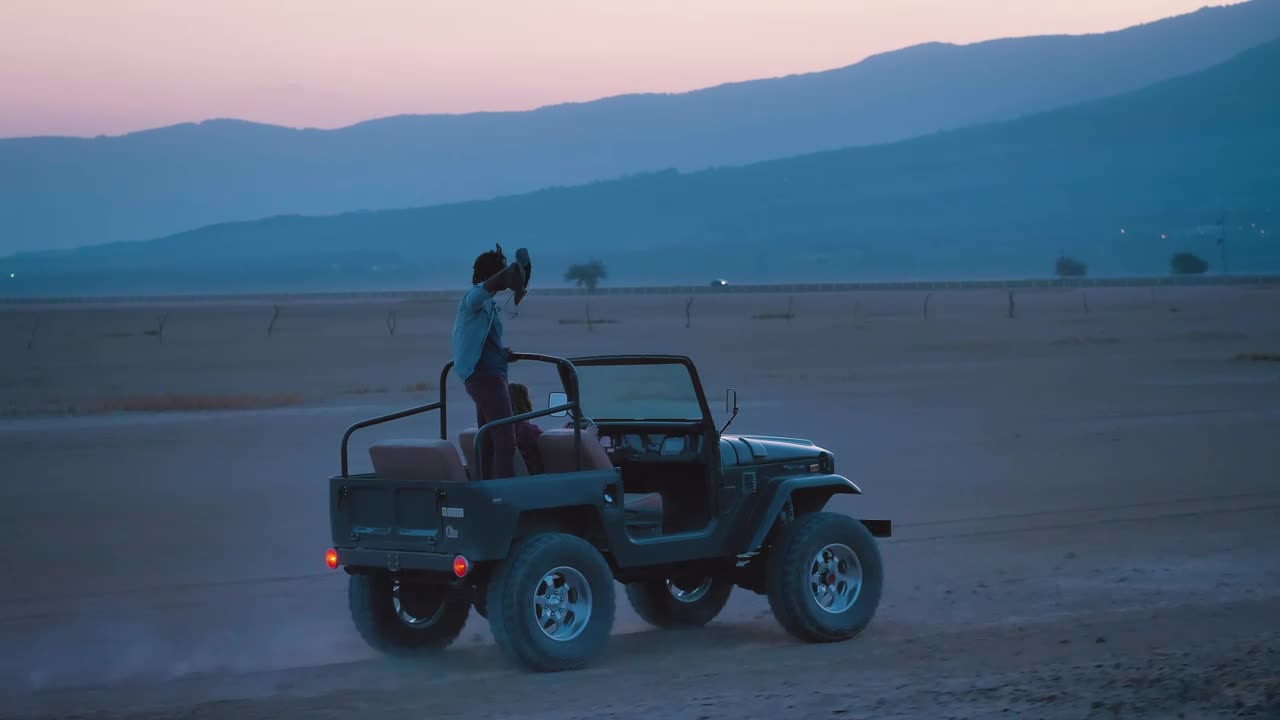 Stock Video Couple Of Friends Traveling Through A Desert On A Road Live Wallpaper For PC - Free Download