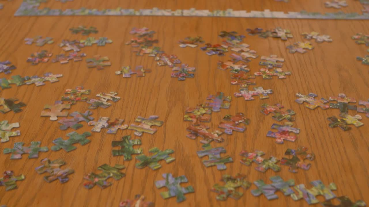 Free Stock Video Woman Putting Together A Puzzle Of Many Pieces Live Wallpaper - Free Download