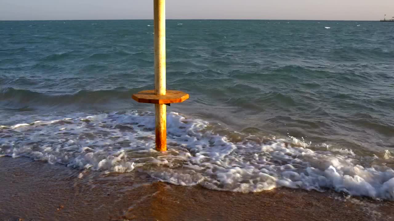 Stock Footage Waves Breaking Around An Umbrella Live Wallpaper - Free Download