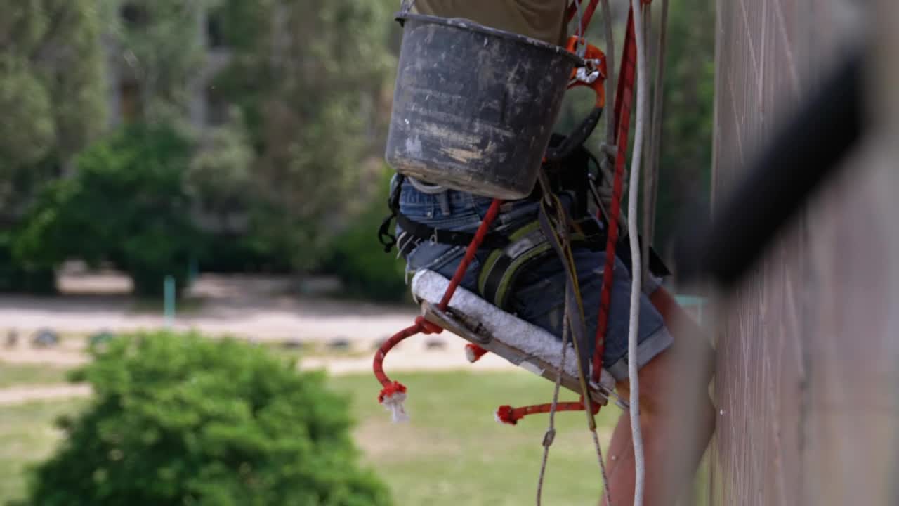 Stock Video Painter Repairing The External Wall Of A Building Live Wallpaper - Free Download