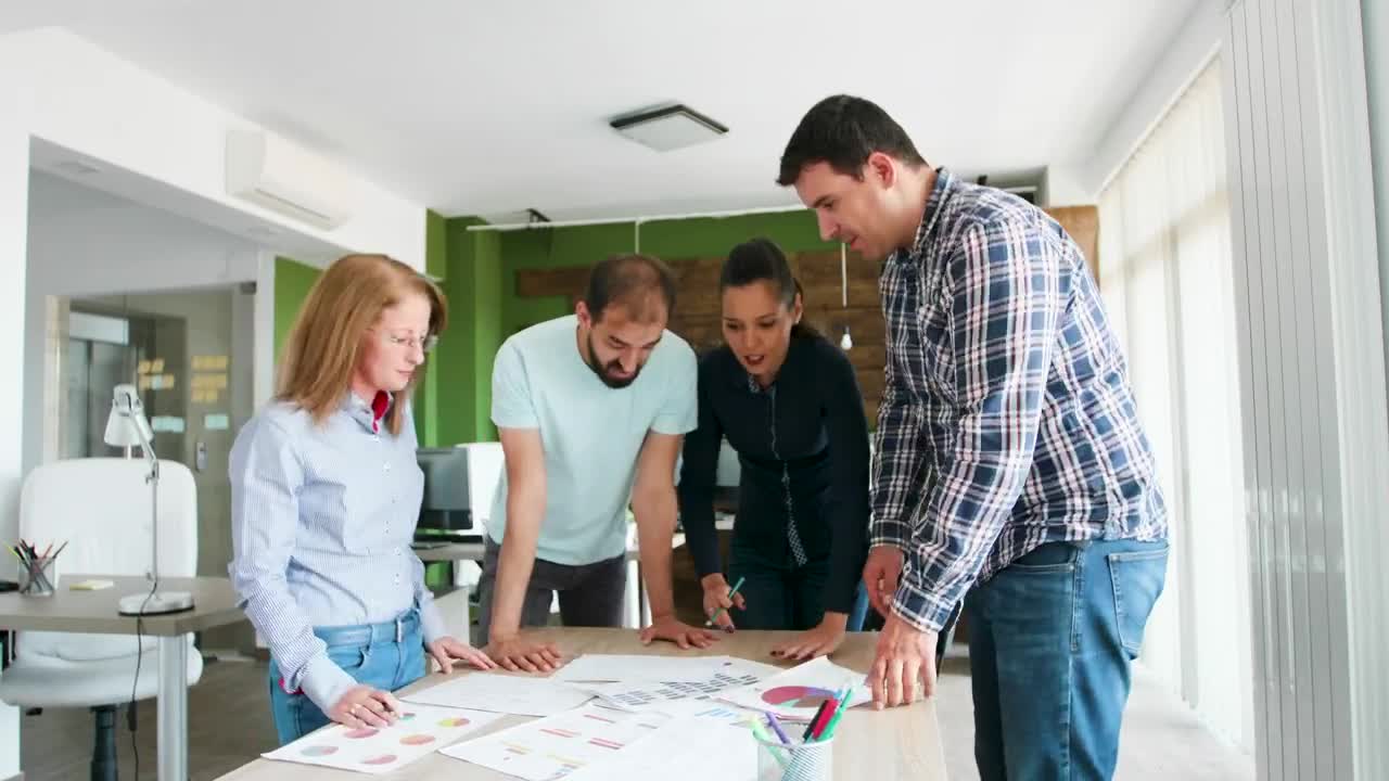 Free Video Stock team collaborates on idea in casual office Live Wallpaper - Free Download