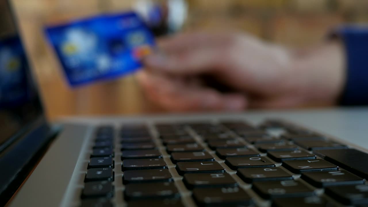 Stock Video Finger Typing And Unfocused Hand Holding Credit Card Live Wallpaper For PC - Free Download