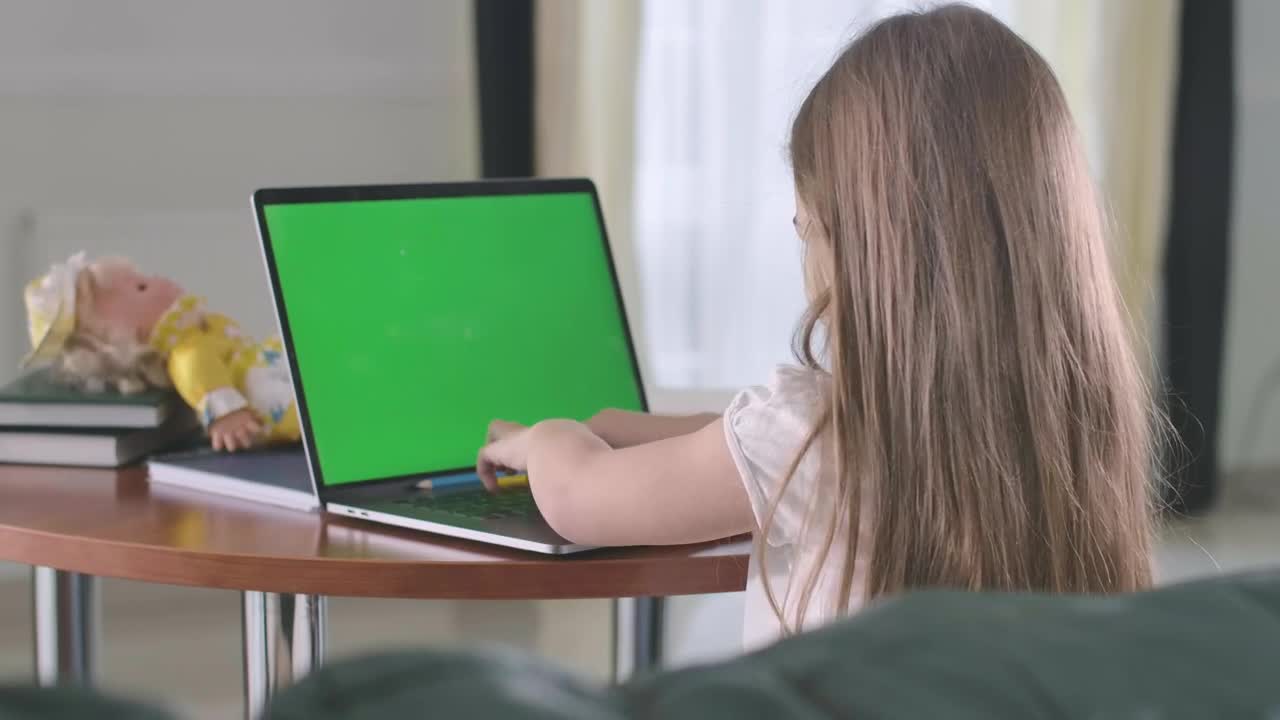 Stock Video Little Girl Doing Homework On A Laptop Animated Wallpaper - Free Download