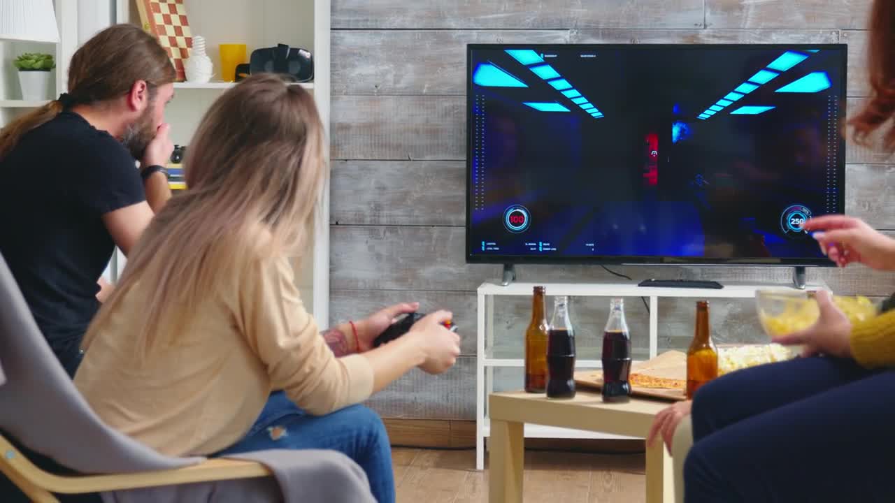 Stock Video Friends Enjoy Video Gaming On Sofa At Party Live Wallpaper For PC - Free Download