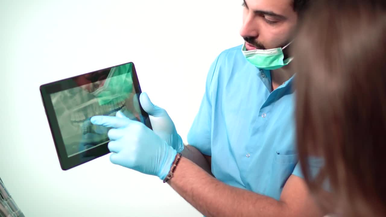 Stock Video Dentist Shows Patient Teeth On X Ray Live Wallpaper For PC - Free Download