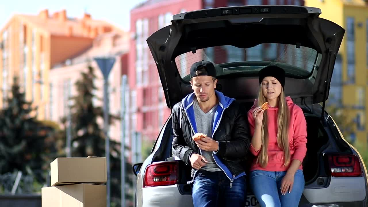 Stock Video Friends Laughing And Eating Sitting In A Car Trunk Live Wallpaper For PC - Free Download