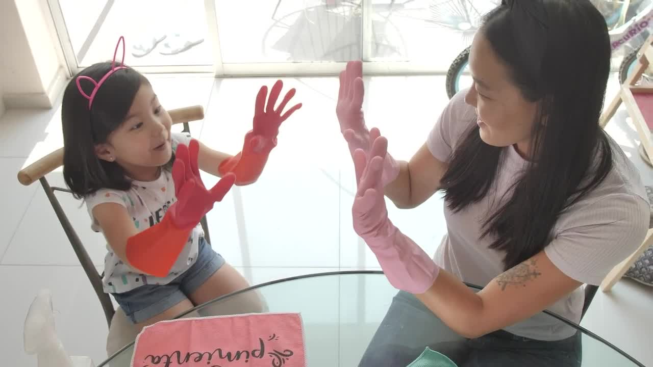 Stock Video Hi Five Between Mother And Daughter For Cleaning Their House Animated Wallpaper - Free Download