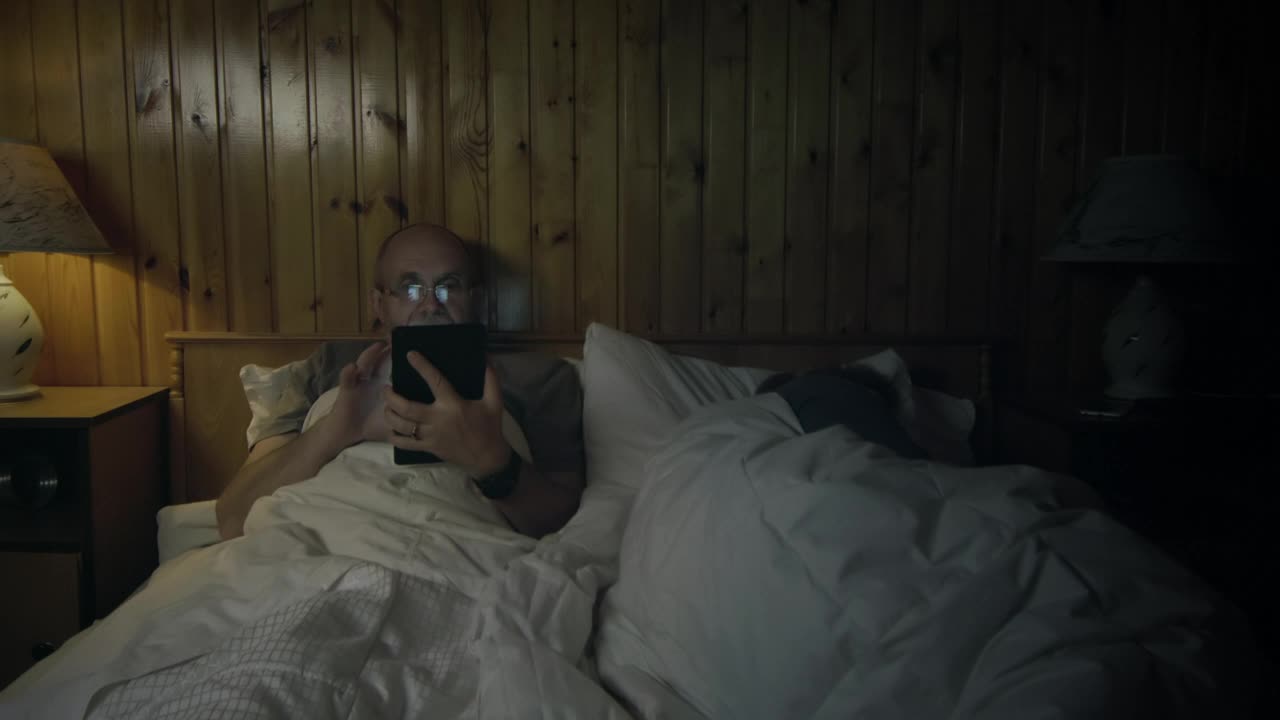 Stock Video Man Watching The Tablet In The Bedroo Animated Wallpaper - Free Download