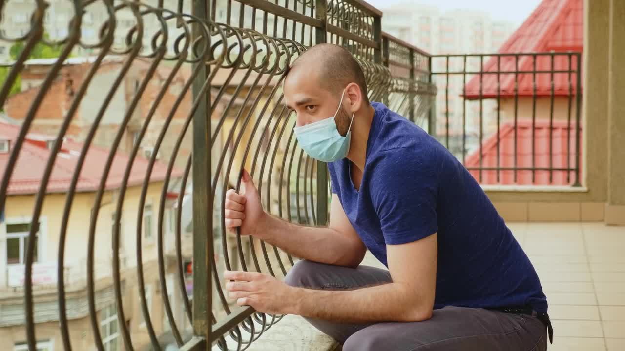 Stock Video Coronavirus Worries Man In Face Mask Sitting On Balcony Live Wallpaper For PC - Free Download