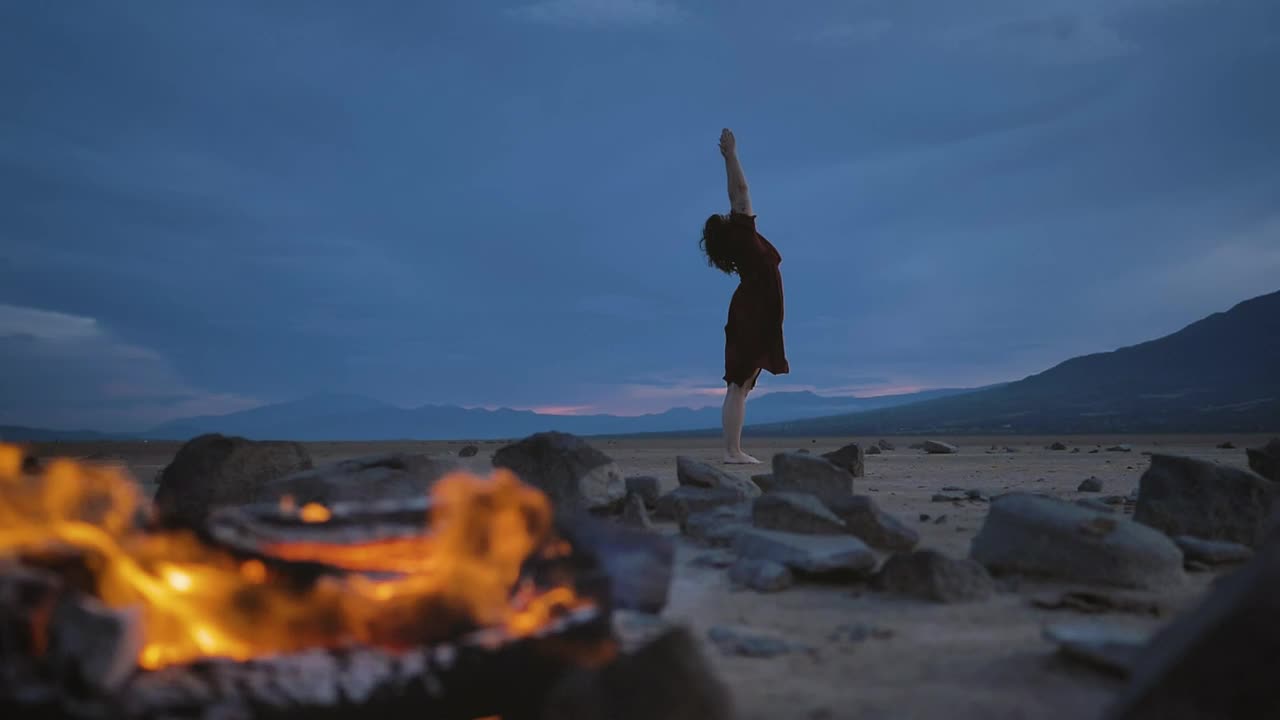 Stock Video Deserted Plain With A Campfire And A Woman Practicing Yoga Live Wallpaper For PC - Free Download