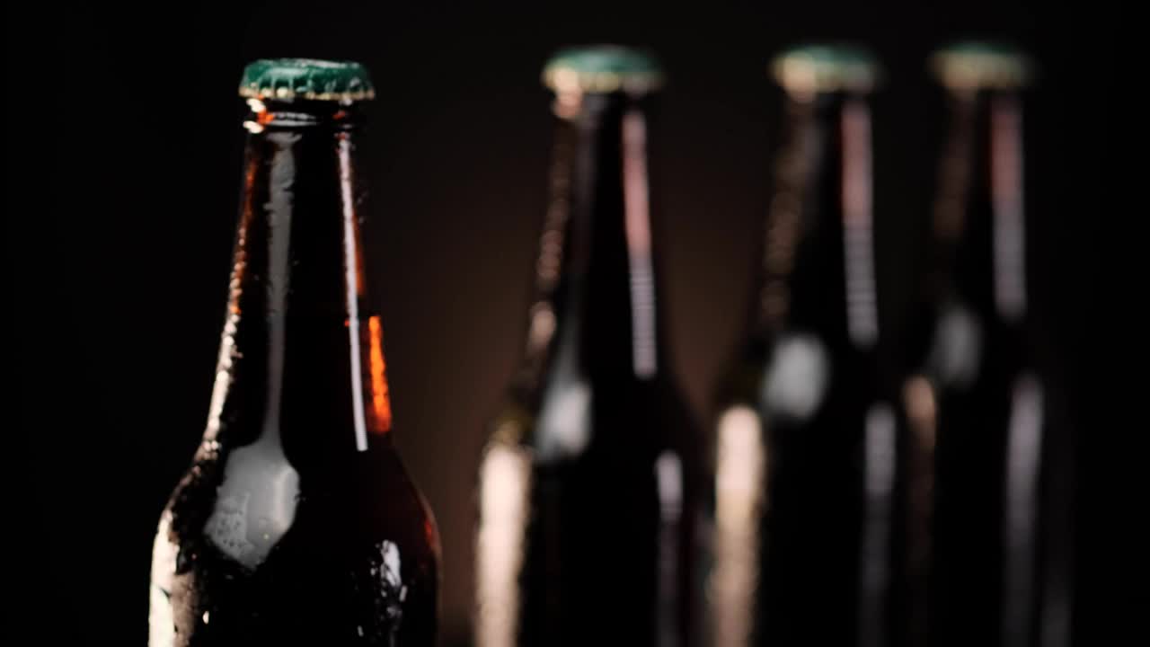 Stock Video Cold Beer Bottles In A Row On A Dark Background Live Wallpaper For PC - Free Download