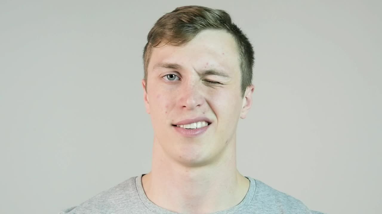 Stock Video Man Winking Against An Isolated Backgroun Animated Wallpaper - Free Download