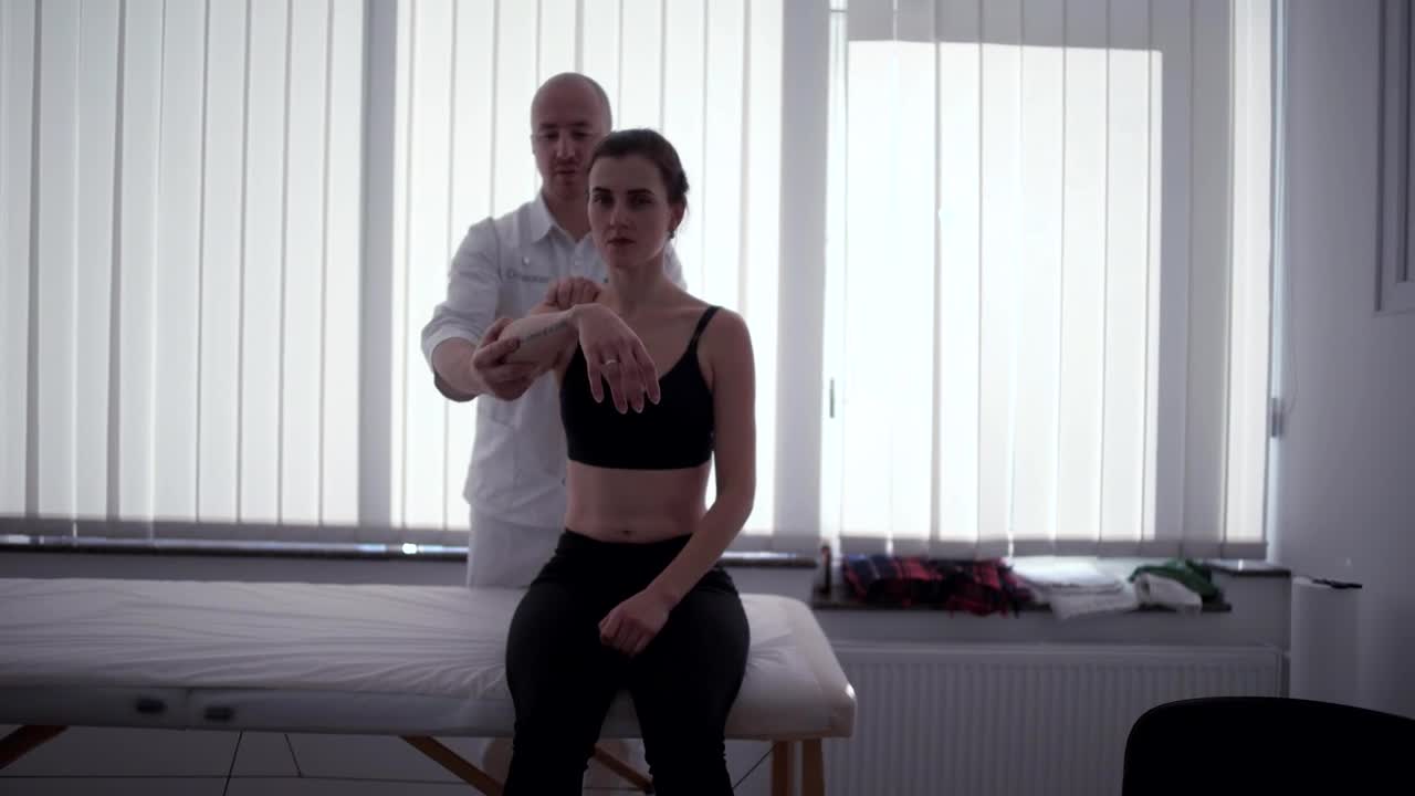 Video Stock Physician Moves Arm Of Female Patient Live Wallpaper Free - Free Download