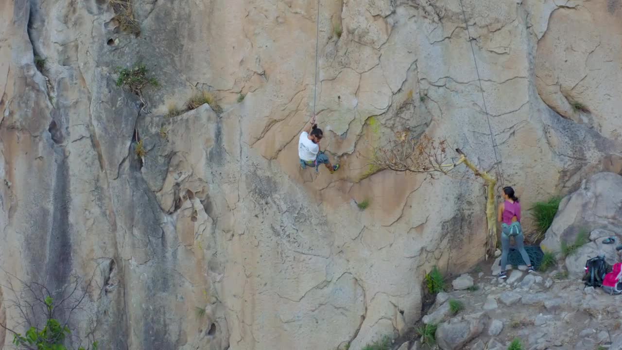 Stock Video Mountaineer Descending From A Mountain With A Rope Live Wallpaper - Free Download
