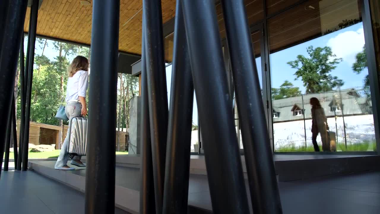 Stock Footage Woman Carrying A Suitcase Arriving At A Hotel Live Wallpaper - Free Download