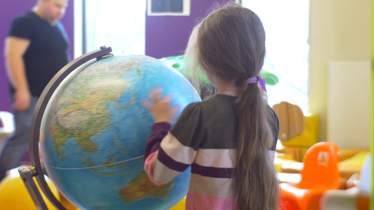 Stock Video Girl Rotating An Earth Globe At School Live Wallpaper For PC - Free Download