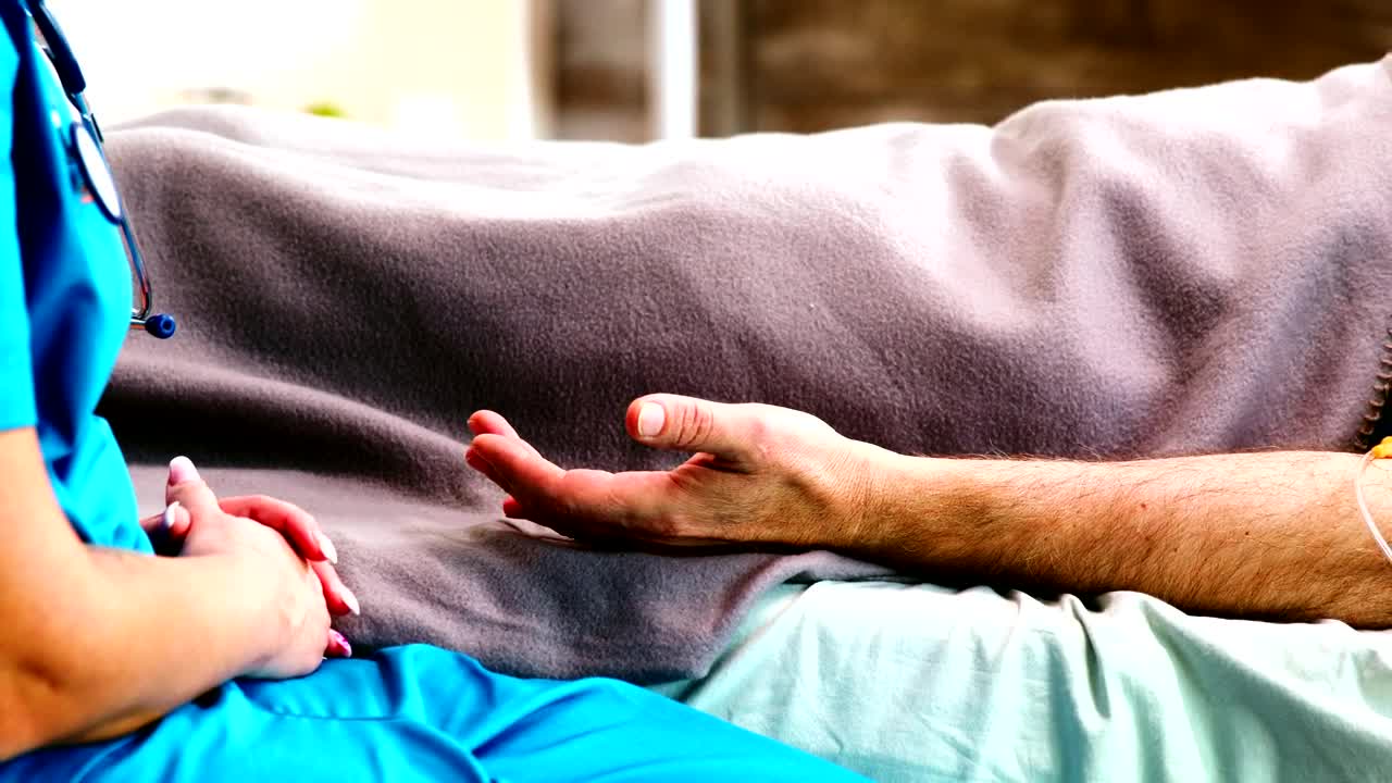 Free Stock Video Sick Man On Bed Comforted By Nurse Holding Hands Live Wallpaper - Free Download