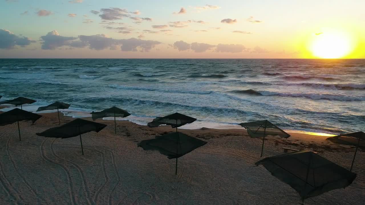 Free Video Stock sunset on a beach with wind and umbrellas Live Wallpaper - Free Download