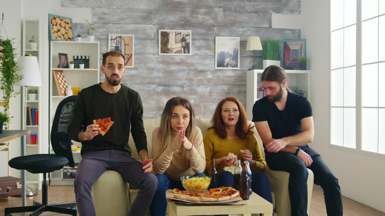 Stock Video Friends Celebrate Sports Victory On Sofa With Pizza Live Wallpaper For PC - Free Download