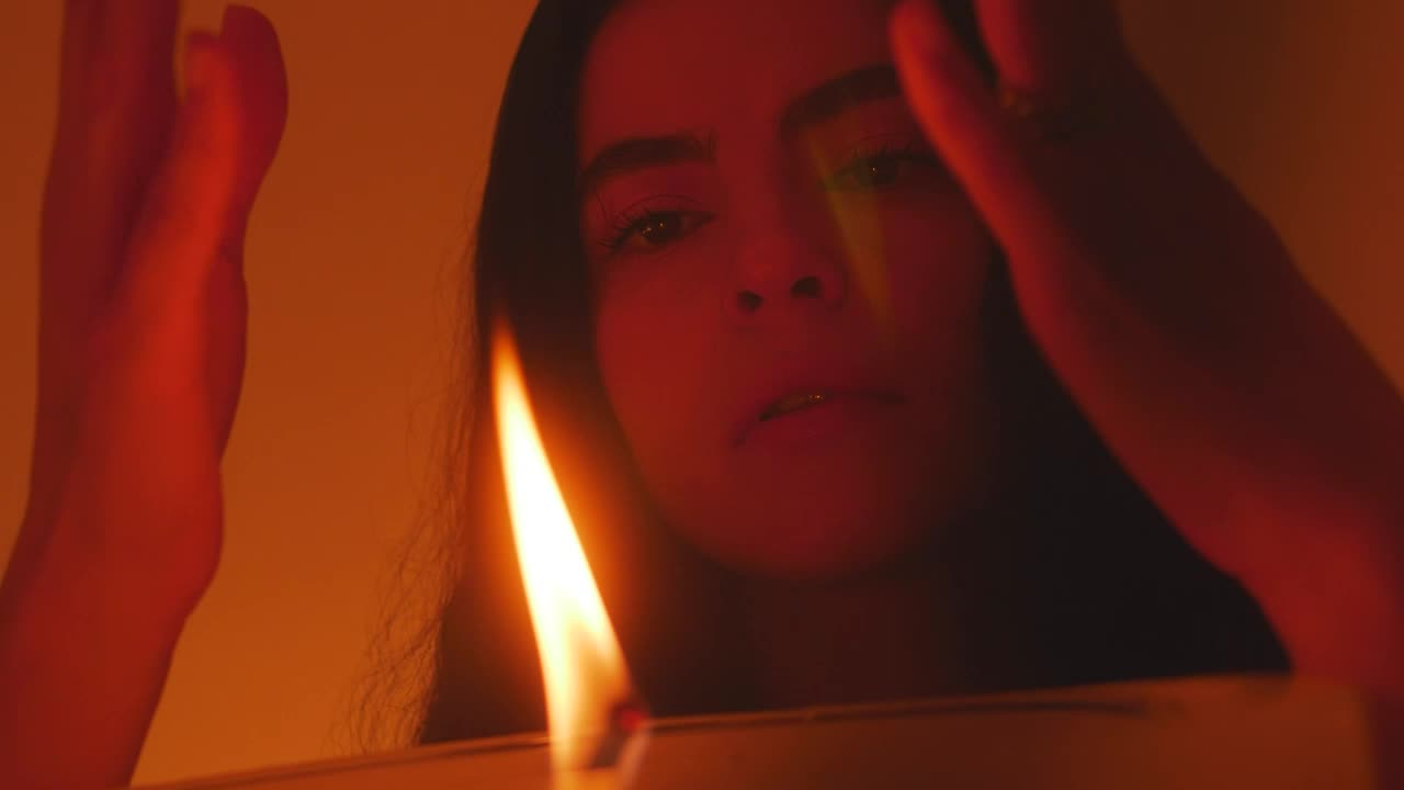 Stock Video Mysterious Woman Appreciating The Flame Of A Candle Live Wallpaper - Free Download
