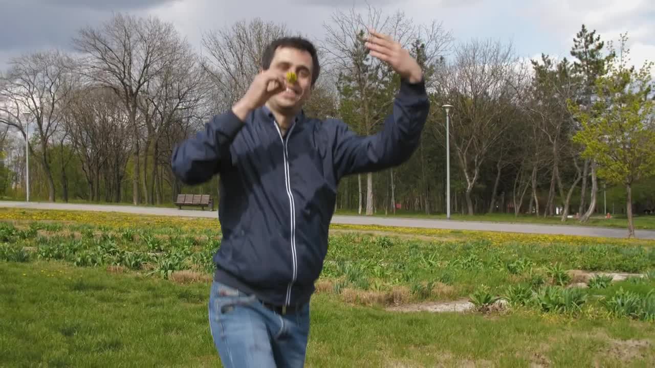 Stock Video Man Runs Happy With A Flower In The Par Animated Wallpaper - Free Download
