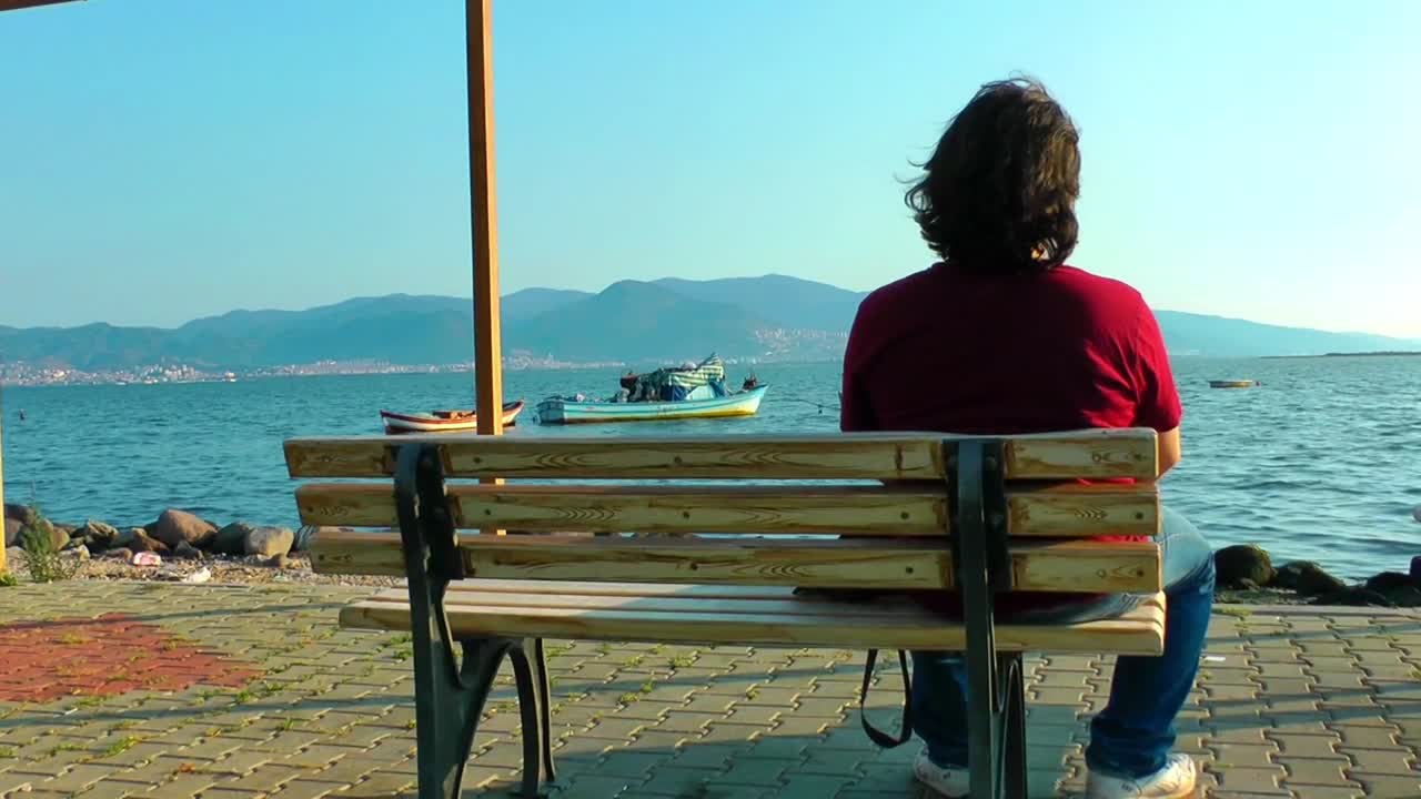 Stock Video Pensive Man Looks At The Sea From A Bench Live Wallpaper - Free Download