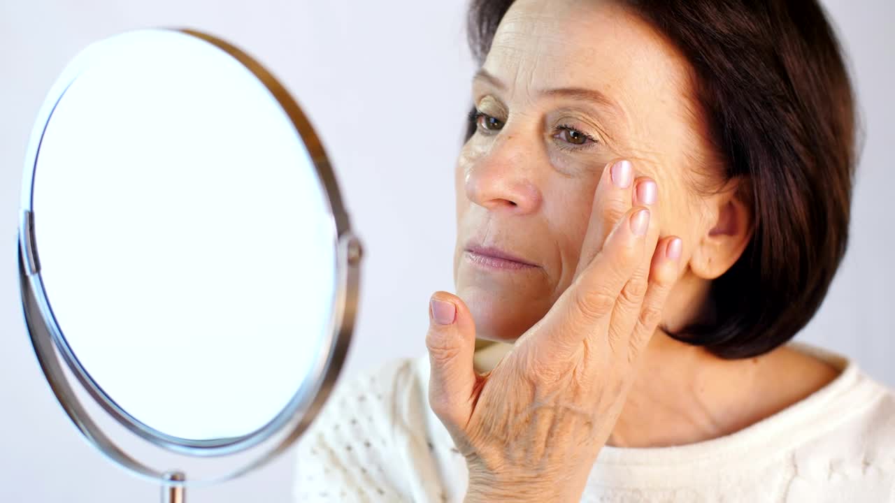 Stock Video Old Woman Happily Looking Her Face In A Mirror Live Wallpaper - Free Download
