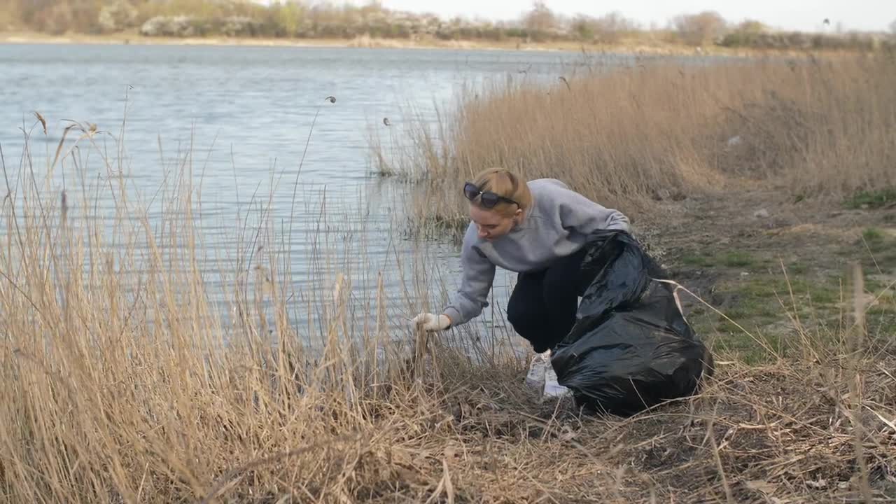 Free Stock Video Volunteer Picking Up Trash By The River Live Wallpaper - Free Download
