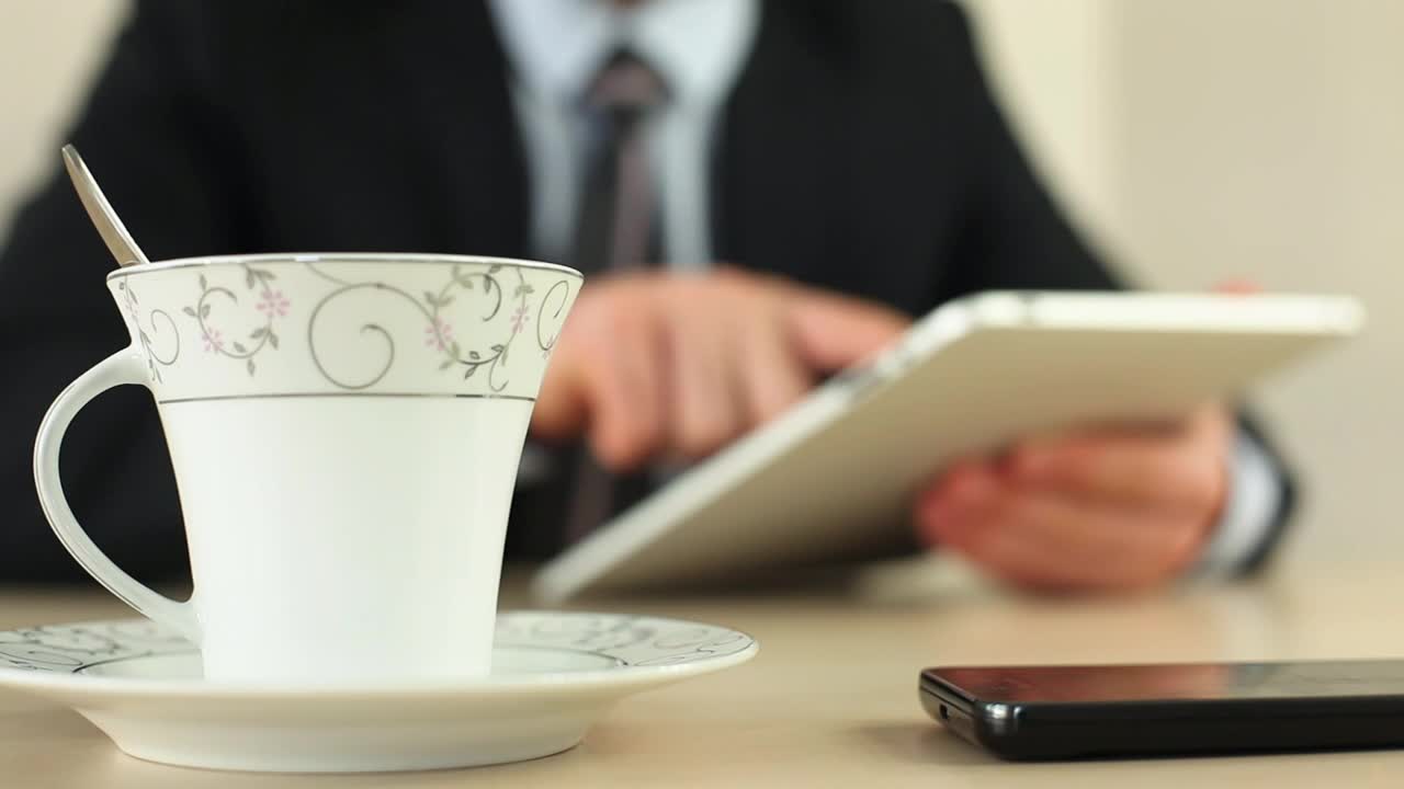 Video Stock Businessman With A Tablet Drinking Coffee Live Wallpaper For PC - Free Download
