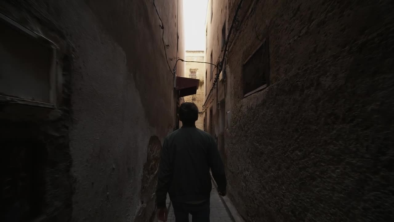 Stock Video Man Walking Through The Narrow Streets Of Morocc Animated Wallpaper - Free Download