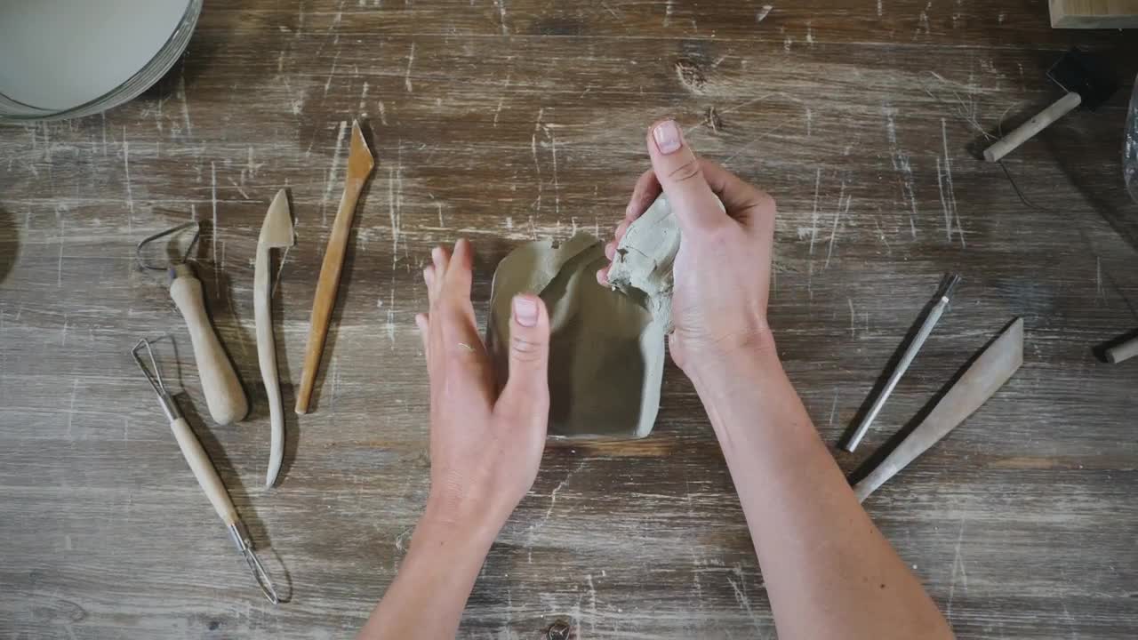 Stock Video Hans Molding Clay In The Workshop Table Animated Wallpaper - Free Download