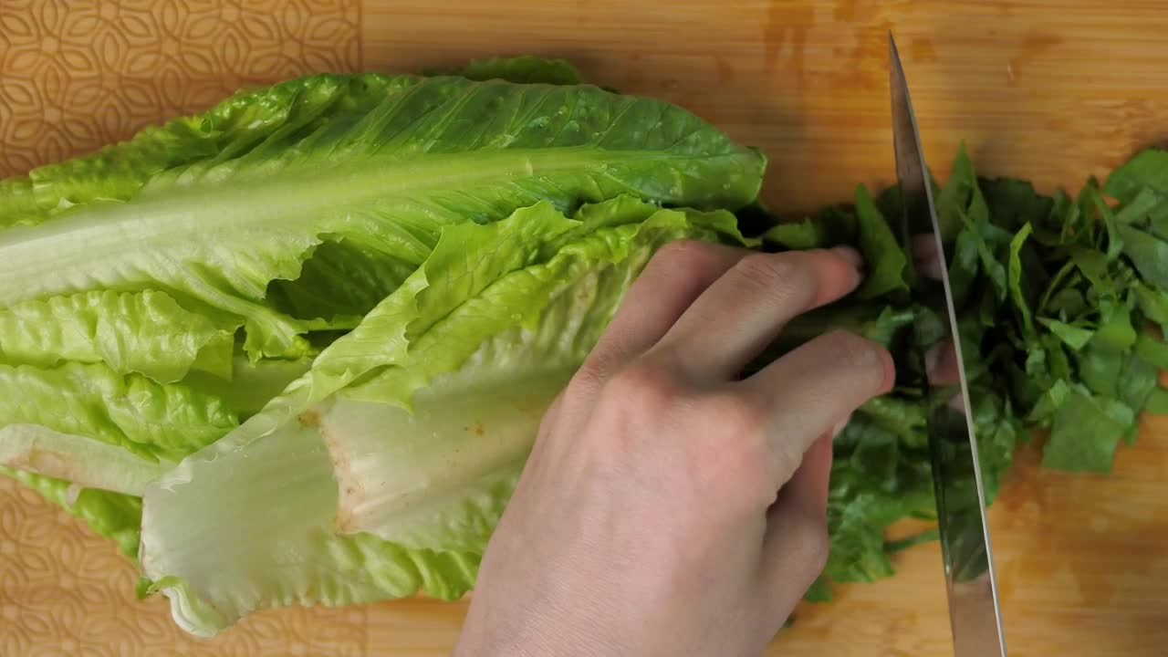 Free Video Stock top view of a person cutting lettuce Live Wallpaper - Free Download