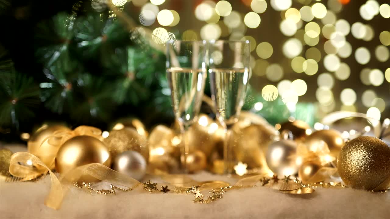 Stock Video Gold Holiday Ornaments And Champagne Glasses On Green Bokeh Live Wallpaper For PC - Free Download